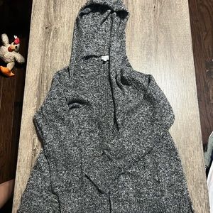 A grey, black, and white knitted and hooded cardigan from Mudd